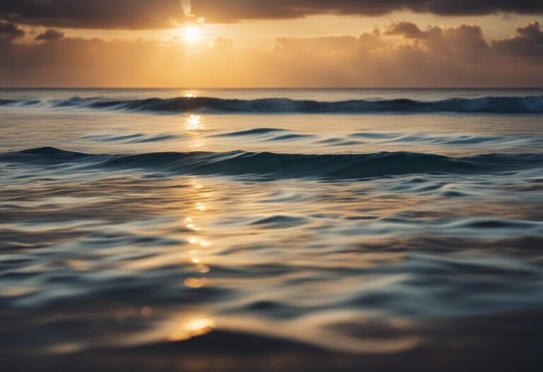 Dreaming About The Ocean: Meanings And Interpretations 12 Dreaming about the ocean at sunset, with gentle waves reflecting the warm colors of the setting sun and a partly cloudy sky.